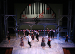 actors dancing with a projected piano in the background