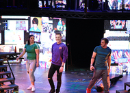 three actors walking toward the audience