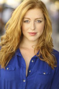 woman with red hair in blue blouse