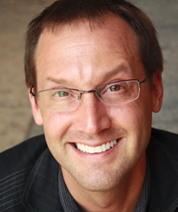 man with brown hair and glasses