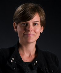 woman with short brown hair in black coat