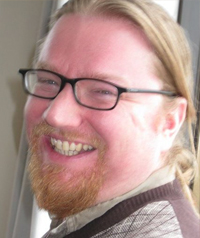 man with long hair, beard, and glasses