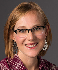 woman in plaid shirt with glasses