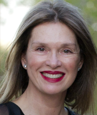 A woman smiles at the camera