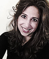 woman with brown hair and head tilted