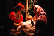 two actors holding an actor who is laying down