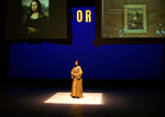 actor illuminated at the center of the star, projected images on the left and right, both pictures or mona lisa