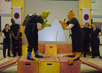 two actors bowing to one another, about to fight