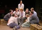 eight actors surrounding one in the middle
