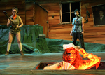 an actor poking out of the floor while two actors watch in the background