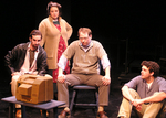 four actors sitting around and watching a small television