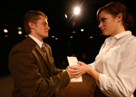 two actors holding onto a piece of paper between them
