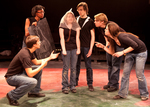four actors surround two actors, questioning them