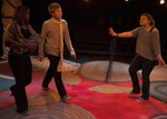actors walking in from the left, and actor on the right is holding up a hand as if to tell them to stop