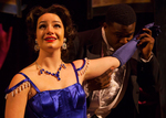 an actor kissing the arm of a woman in a blue dress