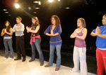 students standing in line with their palms together