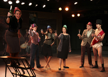 actors in party hats gathered together and making a toast
