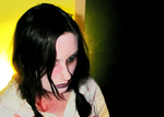 a very pale actor looking down to the right, her neck is bleeding