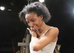 an actor smiling and has left hand reaching to their right cheek