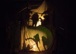silhouettes of actors against a white sheet
