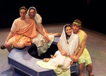 four actors, split by twos, sitting around a well