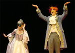 one actor proclaiming something while another listens curiously