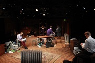two actors sitting in a room, doing their individual actions