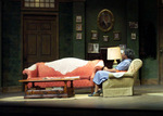 actress sitting in an empty living room
