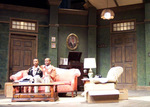 two actors sitting together on a red couch