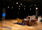 actor sitting at an empty dining table