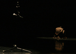dancer on their knees, back to the audience