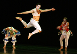 one dance jumping through the air with two dancers in the background