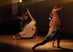dancer reaching toward the sky, two other dancers are posed with their arms out