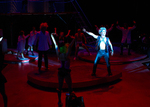 an actor lit up while posing on stage