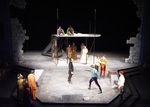 two actors fighting with swords while other actors watch