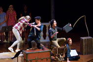 two actors fighting on the left, an actor on the right is singing