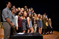 a choir lined up on stands