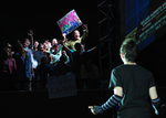 actor standing by himself with a group of actors looking down on him