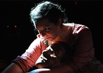 an actor reaching down to the left in the dark