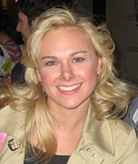 A blonde woman smiles for the camera.