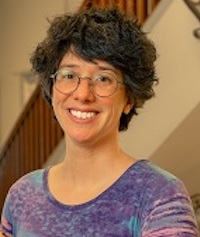 woman with short brown hair and glasses