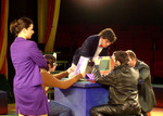 actors gathered around a table working