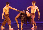two dancers holding another dancer's arms as she dips backward