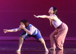 two dancers reaching out in the air desperately