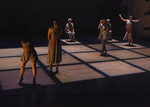 dancers dancing in a set that has rows of lit-up squares