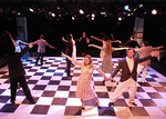 actors dancing together on a checkered floor