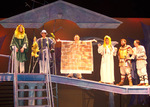 six actors standing on a platform onstage