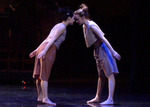 two dancers leaning against one another's foreheads