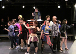 actors split between left and right, facing toward their respective sides with a dance posing in the front and center