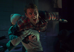 an actor holding a screaming actor on his shoulders